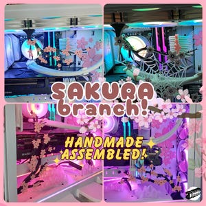 May include: A computer case mod featuring pink sakura branch decorations. The case has internal components with pink and blue lighting. Text on the image reads "SAKURA BRANCH PREMIUM MOD", "SAKURA branch!", and "HANDMADE ASSEMBLED!"