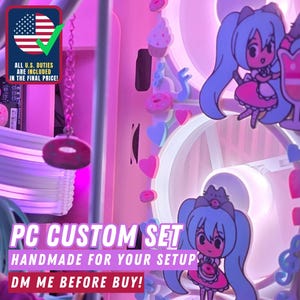 May include: Pink and white PC custom set with anime-style decorations. The image features a PC case with hanging donut and heart-shaped ornaments. The text says "PC CUSTOM SET HANDMADE FOR YOUR SETUP DM ME BEFORE BUY!"