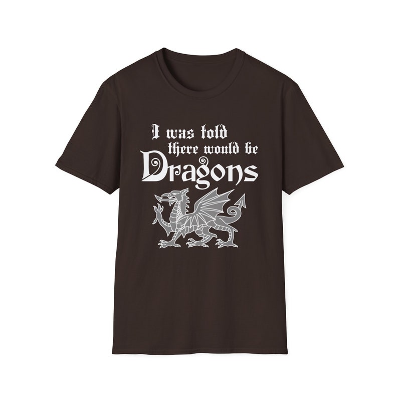 May include: A brown t-shirt with a white graphic that says "I was told there would be Dragons" with a white dragon illustration.