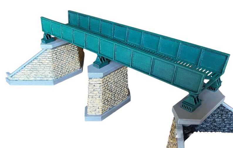 May include: A green metal bridge model with three stone supports. The bridge is made of metal and has a realistic design. The stone supports are made of a light brown material and have a textured surface.