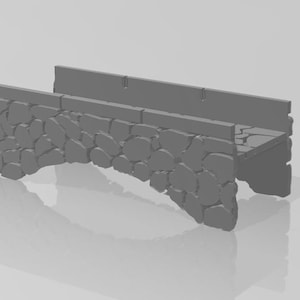 May include: A gray stone bridge model with a flat top and a rounded archway. The bridge is made of small, irregular stones.