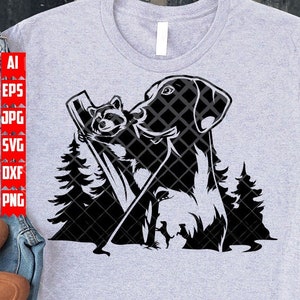 May include: Black and white silhouette of a dog and a raccoon standing on a log in a forest. The dog is looking to the right and the raccoon is looking to the left. The image is on a gray t-shirt.