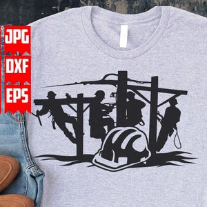 May include: A gray t-shirt with a black silhouette of four linemen working on a power line. A hard hat is in the foreground.