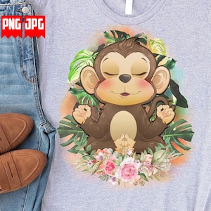 May include: A gray t-shirt with a cartoon illustration of a brown monkey meditating in a jungle setting. The monkey has closed eyes and is surrounded by green leaves and pink flowers.