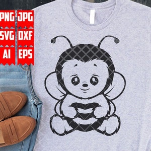 May include: A black and white graphic design of a cartoon bee with large eyes and a striped body. The bee is sitting with its wings out and its legs crossed. The design is on a gray t-shirt.