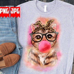 May include: A gray t-shirt with a watercolor illustration of a cat wearing glasses and a leopard print bandana. The cat is blowing a pink bubble.