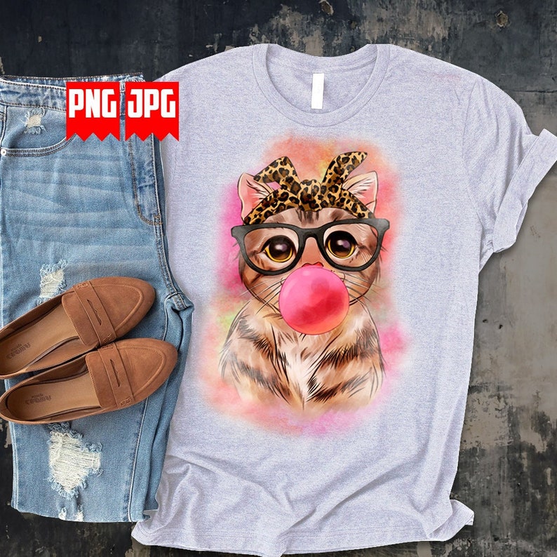 May include: A gray t-shirt with a watercolor illustration of a cat wearing glasses and a leopard print bandana. The cat is blowing a pink bubble.