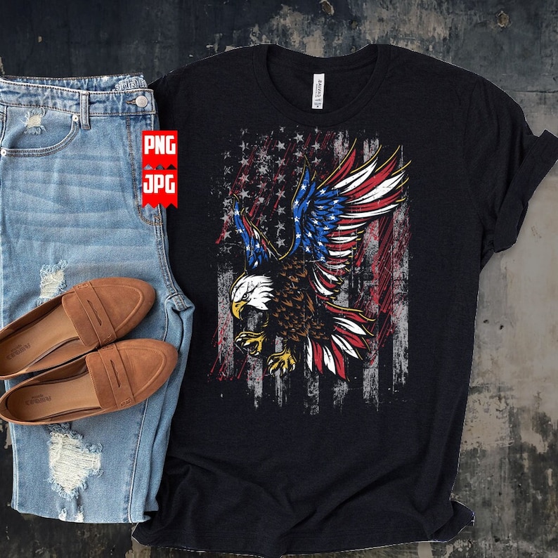 May include: A black t-shirt with a distressed American flag design featuring a bald eagle with its wings spread. The eagle is flying in front of the flag, which has red, white, and blue stripes and stars.