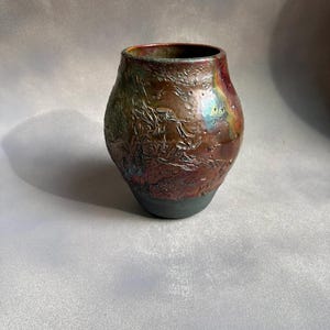 Handmade Ceramic Raku Vase - Red, Iridescent Glaze and Smoky Raw Clay Bottom. Measures 7.25&quot; tall.