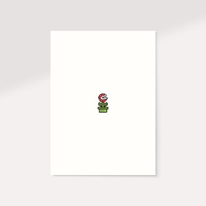 K&ouml;nnte beinhalten: Minimalistische Illustration einer Piranha-Pflanze aus der Super Mario-Videospielserie. Die Pflanze mit ihrem roten Kopf und wei&szlig;en Z&auml;hnen befindet sich in einem gr&uuml;nen Topf. Das Bild ist vor einem wei&szlig;en Hintergrund.
