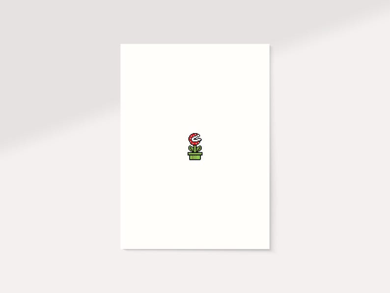 K&ouml;nnte beinhalten: Minimalistische Illustration einer Piranha-Pflanze aus der Super Mario-Videospielserie. Die Pflanze mit ihrem roten Kopf und wei&szlig;en Z&auml;hnen befindet sich in einem gr&uuml;nen Topf. Das Bild ist vor einem wei&szlig;en Hintergrund.