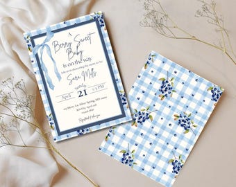 May include: Two baby shower invitations. One features text: "A Berry Sweet Baby is on the way." The other has a blue gingham pattern with blueberry illustrations. Both have a blue border and ribbon.