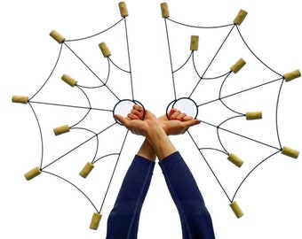May include: A pair of black metal fire poi with 12 wooden wicks. The poi are held by a person with their arms raised above their head.