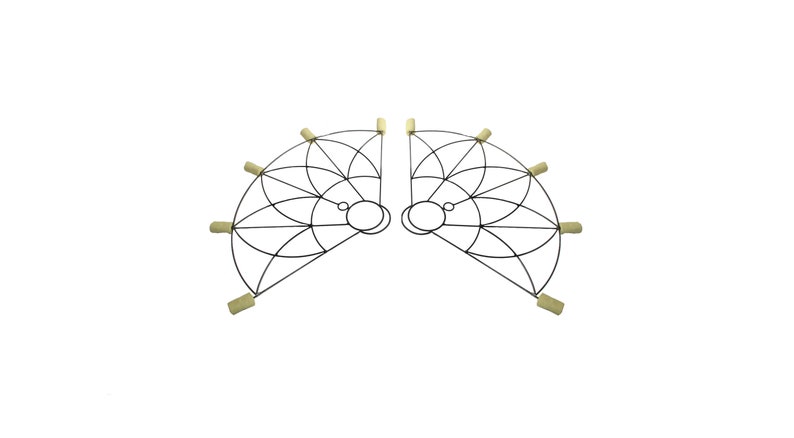 May include: Two symmetrical, semi-circular fire fans. Each fan has a black metal frame with a geometric design and several wicks at the ends. The wicks are a light tan colour. The fans are designed for performance or entertainment.