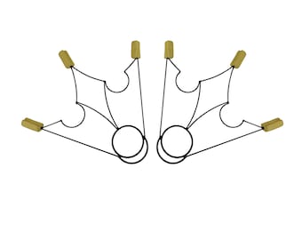May include: A set of two black metal hoops with wooden handles. Each hoop has a decorative design with a pointed shape at the top and a rounded shape at the bottom.