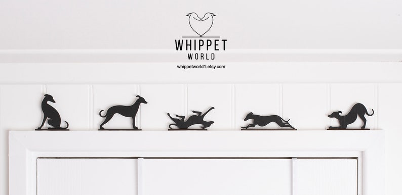 May include: Black metal whippet dog silhouettes in various poses, displayed on a white surface. The silhouettes depict the dogs sitting, standing, rolling, running, and playing. The text "WHIPPET WORLD" and a website address are visible.