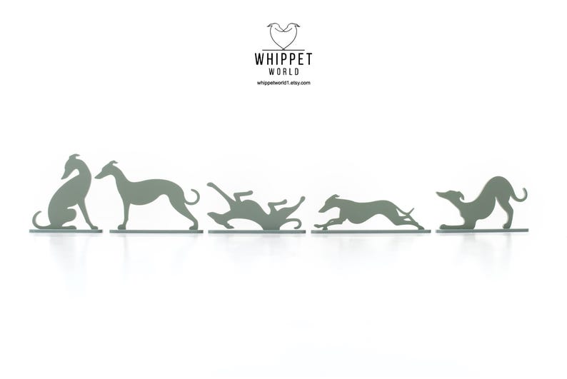 May include: A series of five grey metal whippet dog silhouettes in various poses, from sitting to running. The Etsy shop logo, "WHIPPET WORLD," is at the top, with the shop's website address below. The dogs are on a white background.