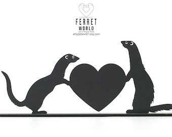 May include: Black metal ferret silhouette holding a heart. The image features two ferrets, one on each side of a heart, with the words "Ferret World" and a website address at the top.