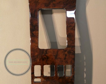 May include: A dark brown wood panel with a rectangular cutout and several smaller rectangular cutouts. The panel has a glossy finish.