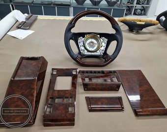 May include: A set of six wood veneer car interior trim pieces in a dark brown wood grain pattern. The pieces include a center console, a gear shift surround, a door panel, and two smaller pieces. The pieces are all made of high-quality wood veneer and have a glossy finish. The text "WOOD & CARBON WORKS" is visible in the lower left corner of the image.