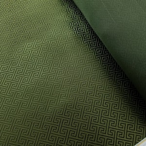 May include: Green fabric with a raised geometric pattern. The fabric has a subtle sheen and a soft texture.