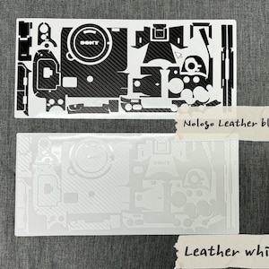 May include: Two camera skin templates, one black and one white, with a carbon fibre pattern. The black template has the text "Nologo Leather black" and the white template has the text "Leather white".