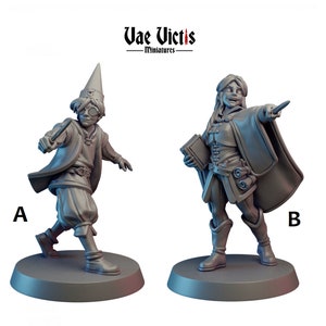 May include: Two grey painted miniature figurines of fantasy characters. The figure on the left is wearing a pointed hat, a long robe, and holding a wand. The figure on the right is wearing a long robe and holding a book. The figures are standing on round bases.