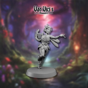 May include: A grey painted miniature figurine of a fairy playing a harp. The fairy has wings, a floral crown, and is wearing a flowing dress. The miniature is standing on a round base.