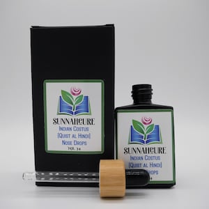 May include: A black bottle and box set with a label that reads "SUNNAHCURE INDIAN COSTUS (QUIST AL HINDI) NOSE DROPS NR. 34". The bottle has a black cap and a wooden stopper. The label features a logo with a book, leaves, and a flower.