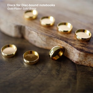 Bez cła w USA. Pozłacane mosiężne krążki do zeszytów w oprawie płytkowej (złoto/nikiel/lit. mosiądz), wysoka jakość, wyprodukowano w Korei Południowej.