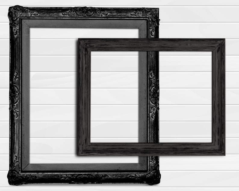 May include: Two black picture frames, one inside the other, against a white wood panel background. The larger frame has a more ornate design.