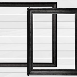 May include: Two black picture frames with ornate detailing, set against a white wood panel background.