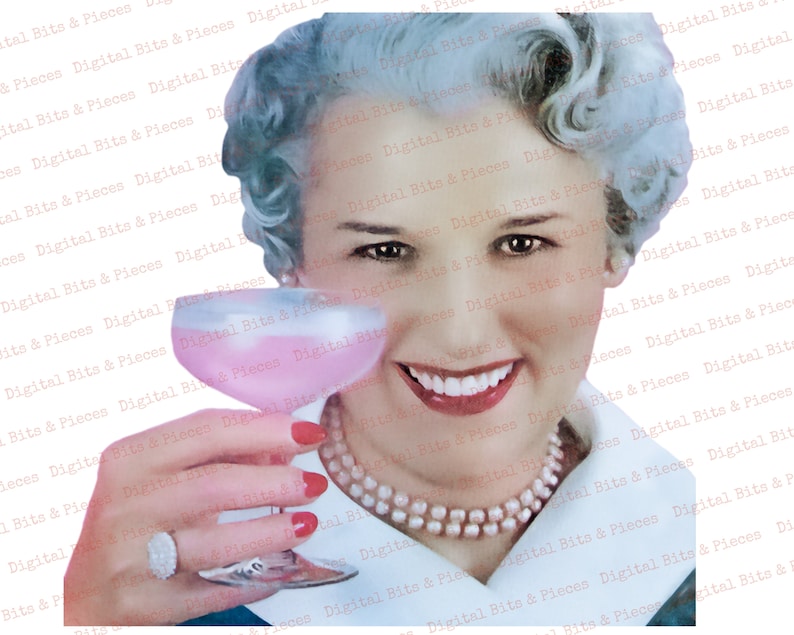May include: A woman with white hair and a pearl necklace smiles while holding a pink cocktail in a clear glass. She is wearing red nail polish and a ring on her finger.