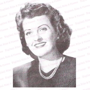 May include: A black and white portrait of a woman with short, wavy hair. She is wearing a dark dress with a pearl necklace. She is smiling and looking directly at the camera.