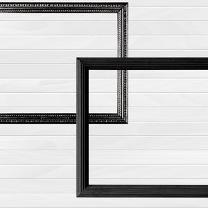 May include: Two black picture frames on a white wood panel background. The frame on the left is ornate with a beaded edge. The frame on the right is simple with a flat edge.