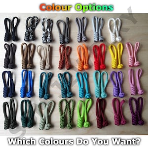May include: A range of colours of zipper pulls, including black, blue, green, red, orange, yellow, purple, and grey. The zipper pulls are arranged in rows on a wooden surface. "Which Colours Do You Want?" is written below the zipper pulls.