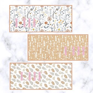 May include: Three rectangular floral patterned designs. The top design has a white background with colorful flowers and the word "III" in pink. The middle design has a tan background with white flowers and the word "III" in pink. The bottom design has a white background with brown and green leaves and the word "III" in pink.