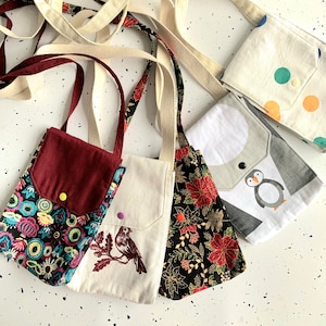 Crossbody phone pouch with snap button closure