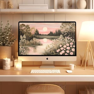 Può includere: Un computer desktop con una scena di paesaggio rosa e verde come sfondo del desktop. Il computer è su una scrivania di legno con una tastiera bianca, un mouse bianco, una lampada bianca e una tazza bianca.