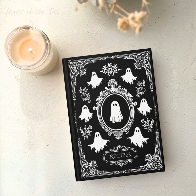 May include: Black recipe journal with a white ornate border and ghost illustrations. The title "Recipes" is printed in white on the front cover.