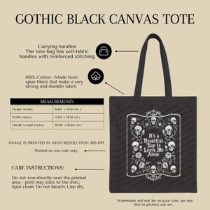 May include: Black canvas tote bag with a gothic design. The bag features a white graphic with skulls and the text "It's a Beautiful Day to Leave Me Alone." The tote is 16 inches high, 15 inches wide, and has 20-inch handles.