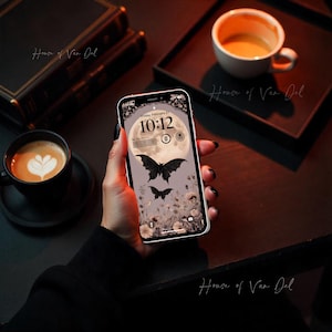 May include: A smartphone displaying a digital clock with the time 10:12, the date Friday, February 21, and a background image of a full moon with two bats flying in front of it. The background is a dark purple with a floral pattern.