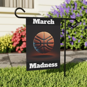 May include: A black garden flag with the text "March Madness" in white lettering. A basketball is featured in the center of the flag.