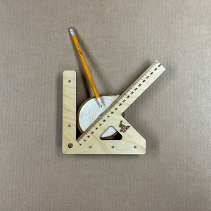 May include: A wooden protractor with a pencil and a wooden circle with concentric rings. The protractor has markings in inches and the circle has a diameter of approximately 10 cm.