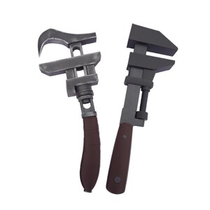 May include: Two adjustable wrenches with dark gray metal heads and brown handles are displayed against a white background. The wrenches are designed for gripping and turning nuts and bolts. One wrench has a curved jaw, and the other has a flat jaw.