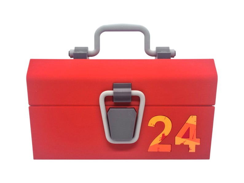 May include: A red toolbox with a gray handle and latch. The number "24" is displayed on the front in orange and yellow. The toolbox is closed and ready for use.