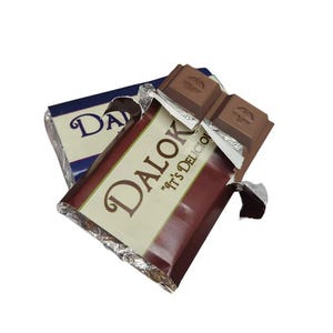 May include: Two partially unwrapped chocolate bars with the brand name "Dalok" visible. The bars are dark brown with silver foil wrapping and a white and brown label. The text "It's Delicious" is also visible.