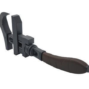 May include: A dark gray adjustable wrench with a brown handle. The tool has a curved jaw and a sliding adjustment mechanism. The handle is textured for grip.