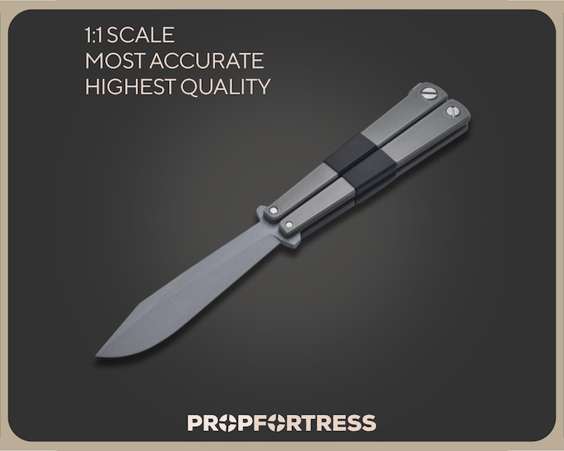 May include: A gray butterfly knife with a silver blade and handle. The handle is accented with black and silver details. The image includes the text "1:1 SCALE MOST ACCURATE HIGHEST QUALITY" and "PROP FORTRESS".