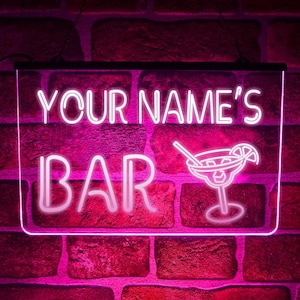 May include: Pink neon sign with the text "YOUR NAME'S BAR" and a margarita glass with a straw and lime wedge.